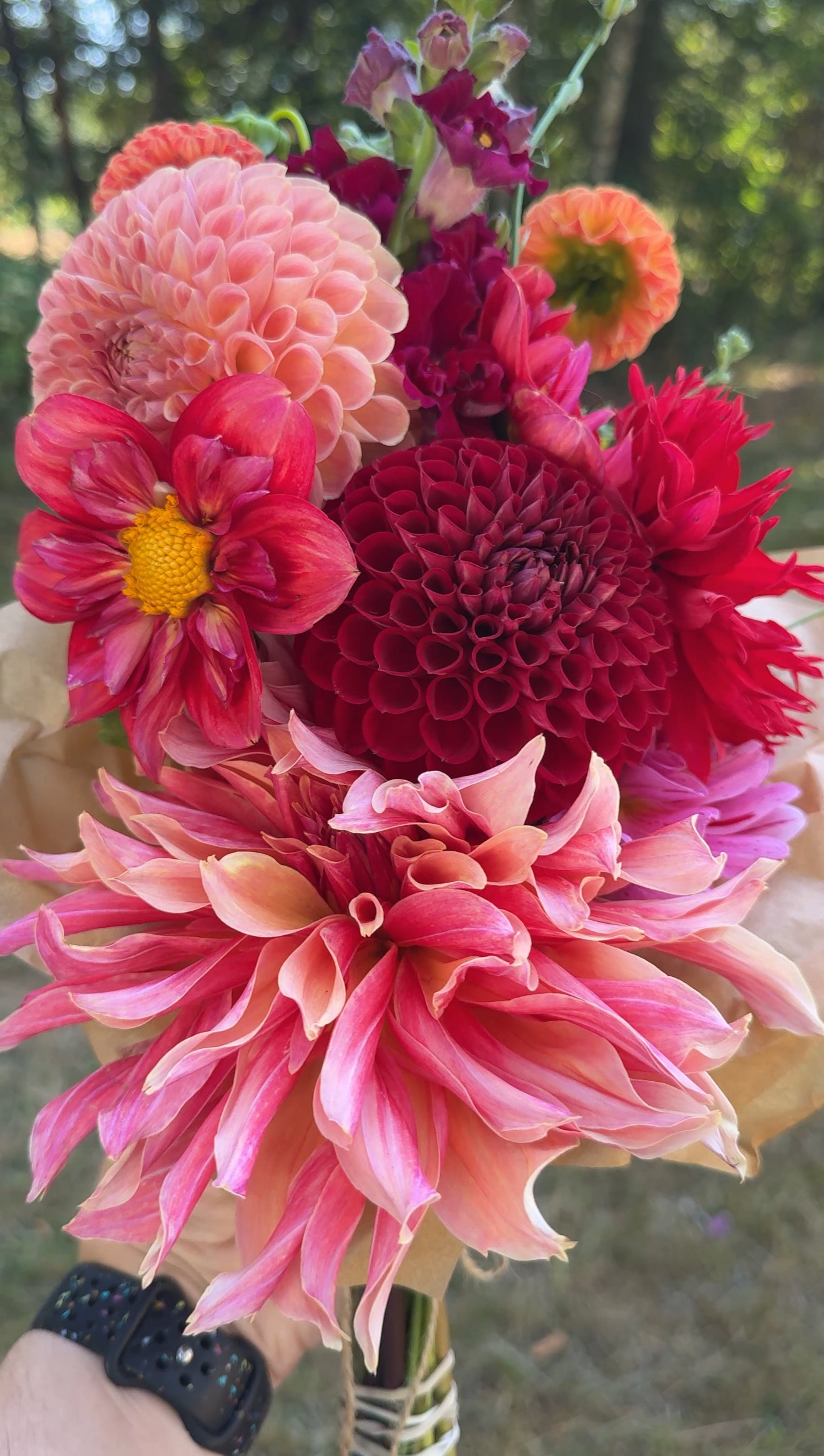 A small market bouquet from Creative Green Gardens featuring red and orange flowers